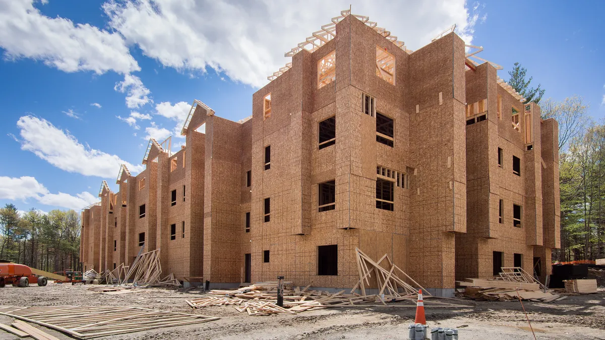 Wood-framed apartment building under construction.