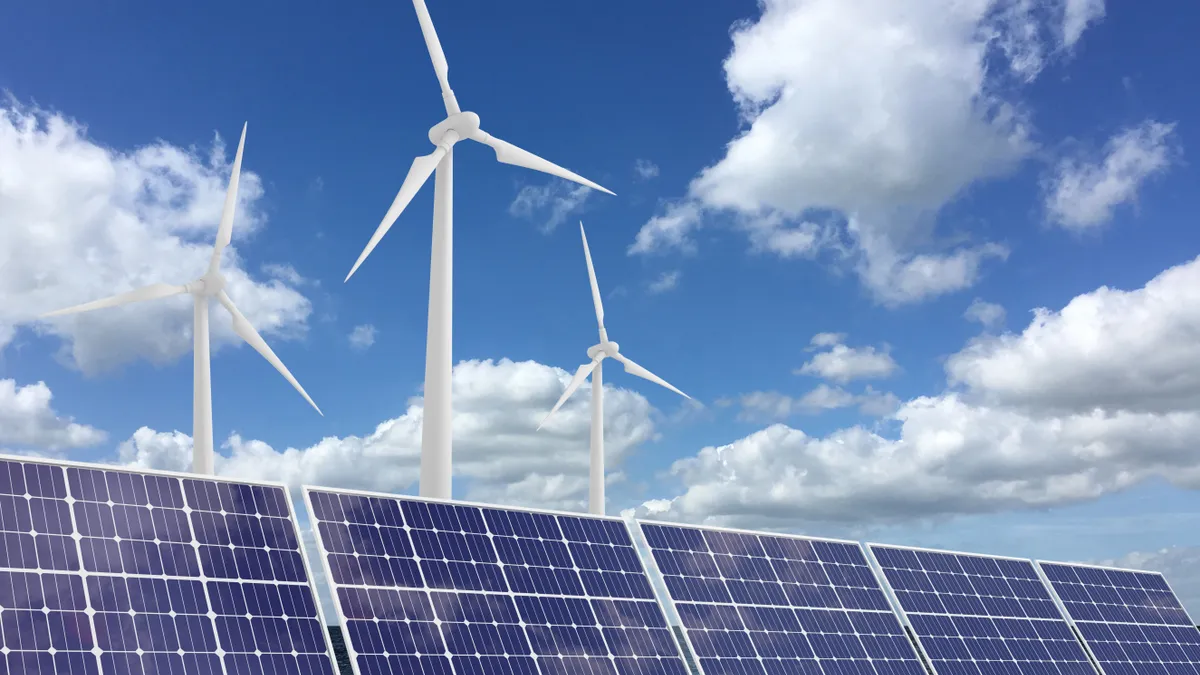 Wind turbines over a set of solar panels.