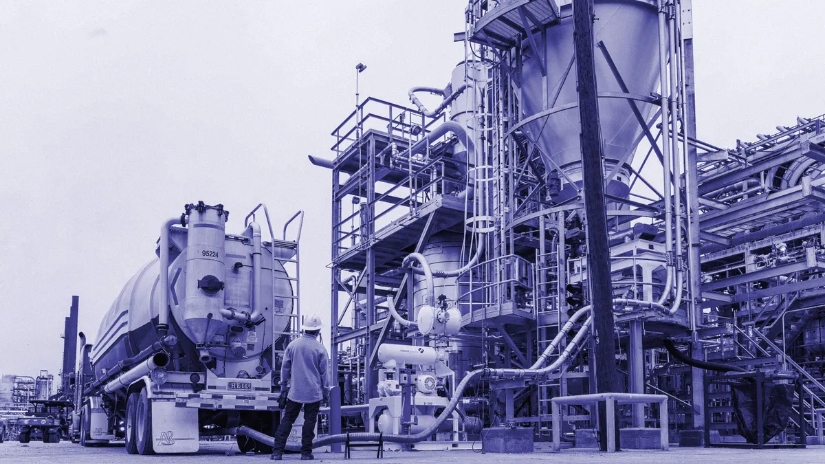 A worker stands in front of ExxonMobil's advanced recycling facility in Baytown, Texas.