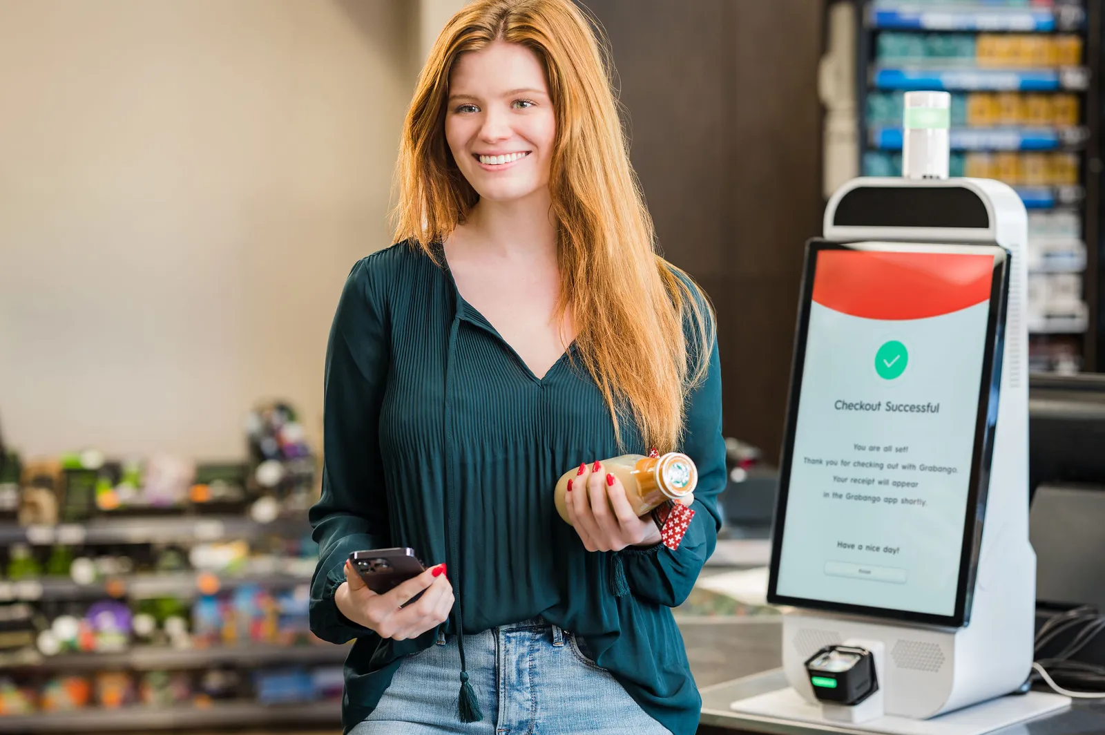 A person standing beside a Grabango scanning kiosk.