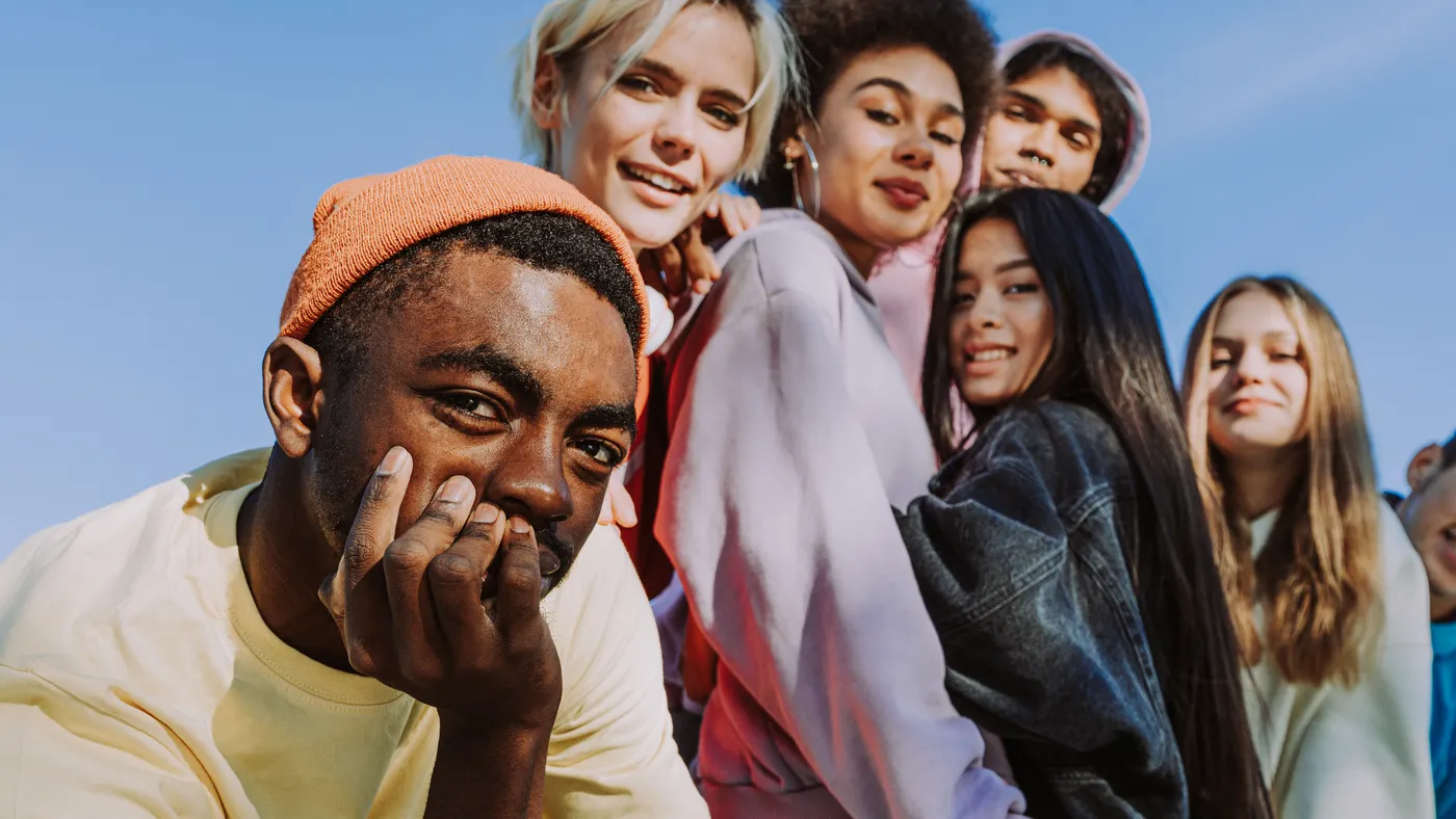 Multicultural group of young friends bonding outdoors