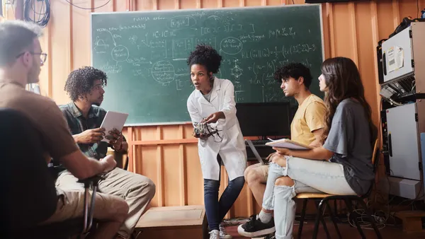 Science professor teaching her students about futuristic technology in the classroom.