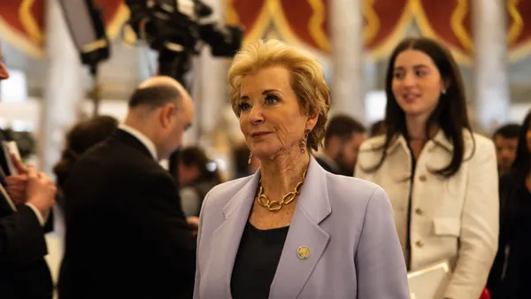 A close-up short of Linda McMahon in a crowded room.