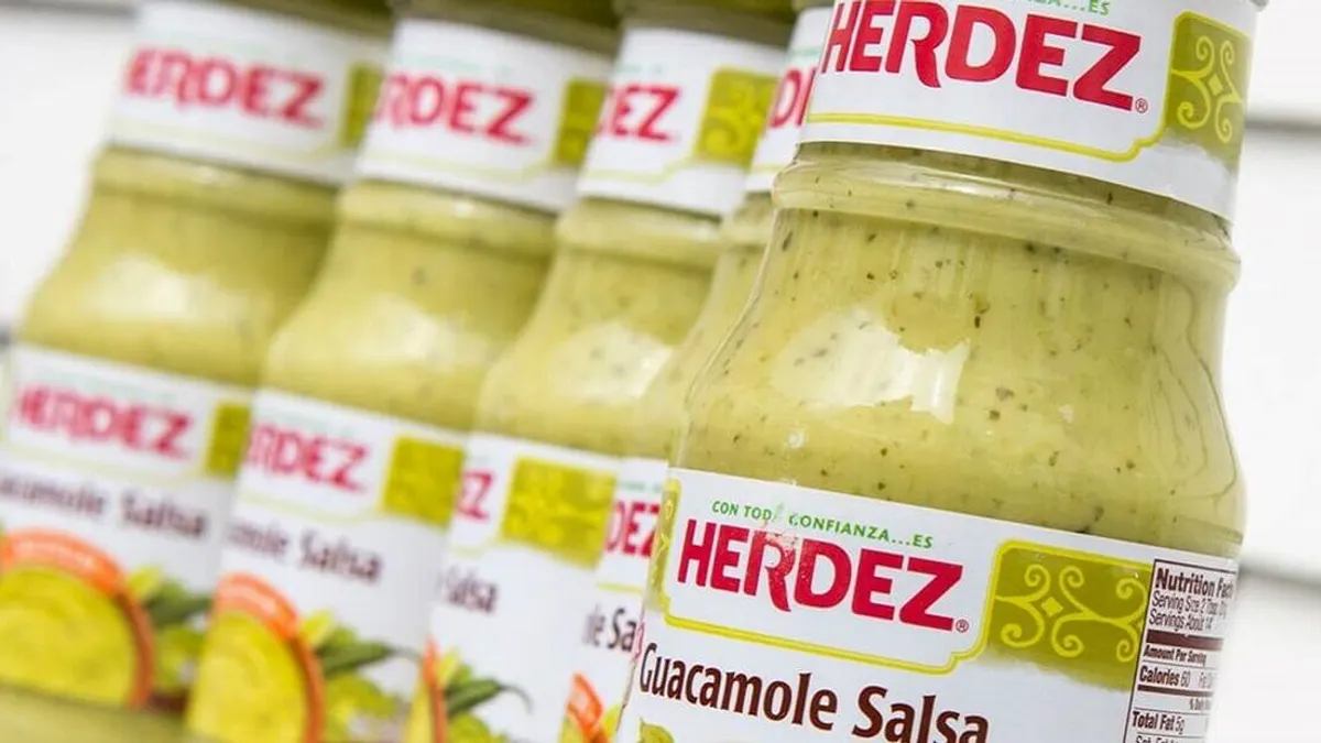 A set of guacamole salsa inside jars with the Herdez logo.