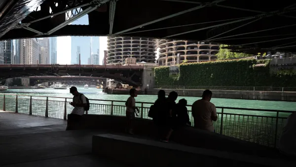 People cool off in the shade of a bridge along Chicago's Riverwalk
