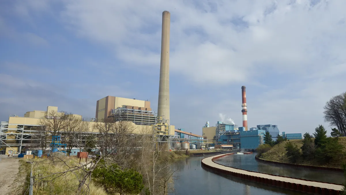 A power plant sites next to a river.