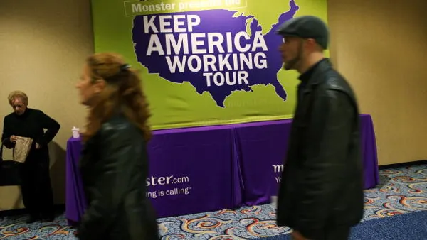 People wait in line at a job fair.