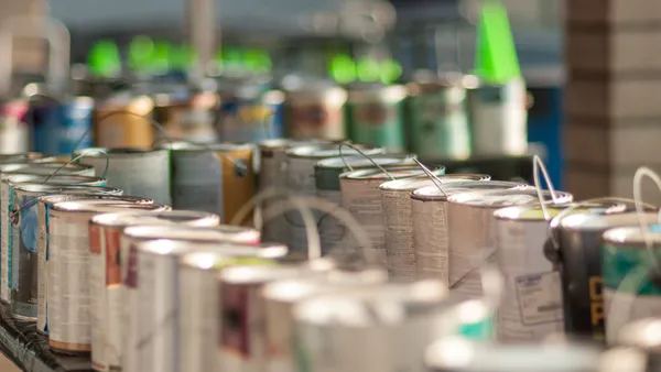 Paint cans sit on shelves
