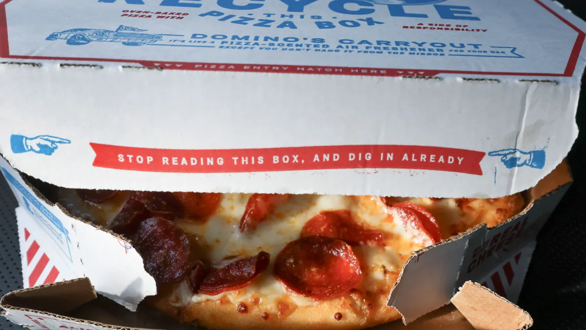 Open box with pepperoni pizza showing through small opening.