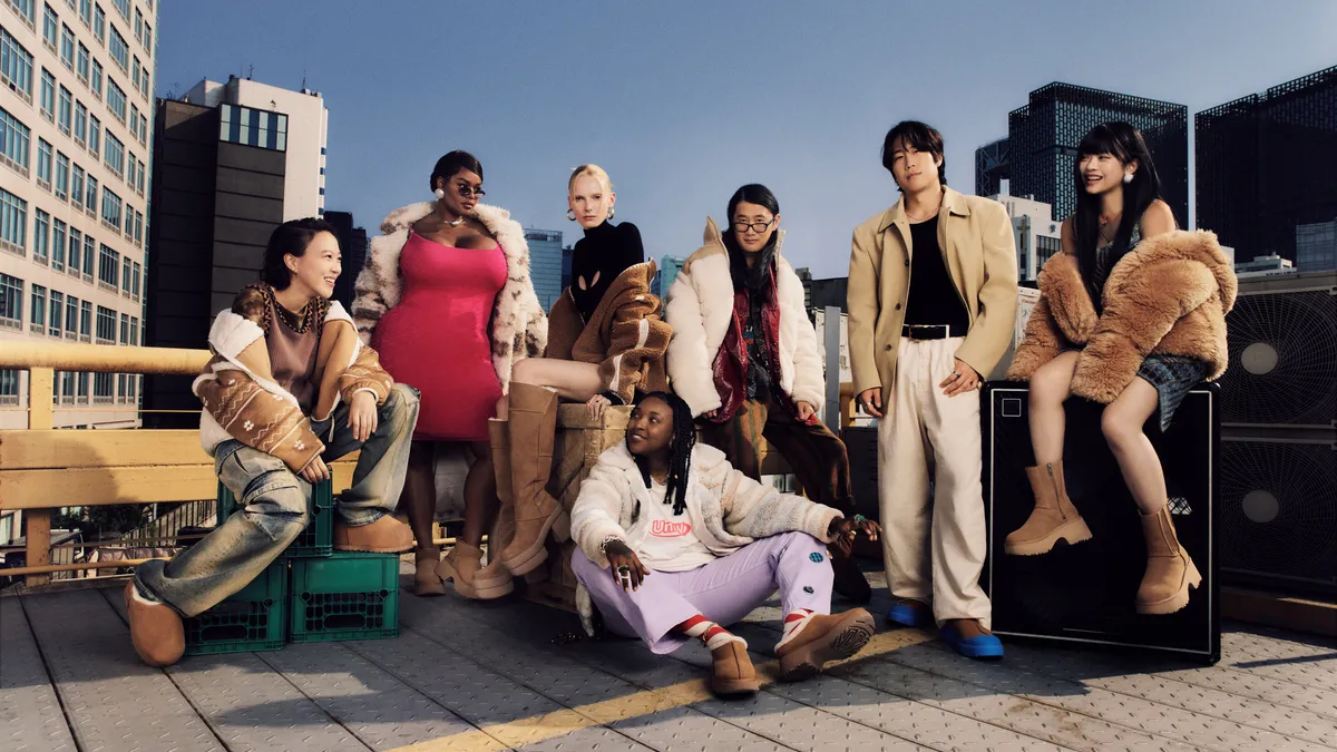 A diverse group of young people pose together on a rooftop.