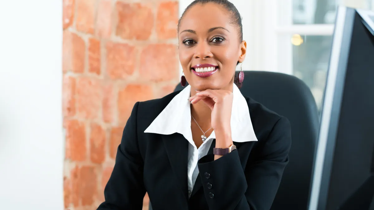 An African-American paralegal working at her desk