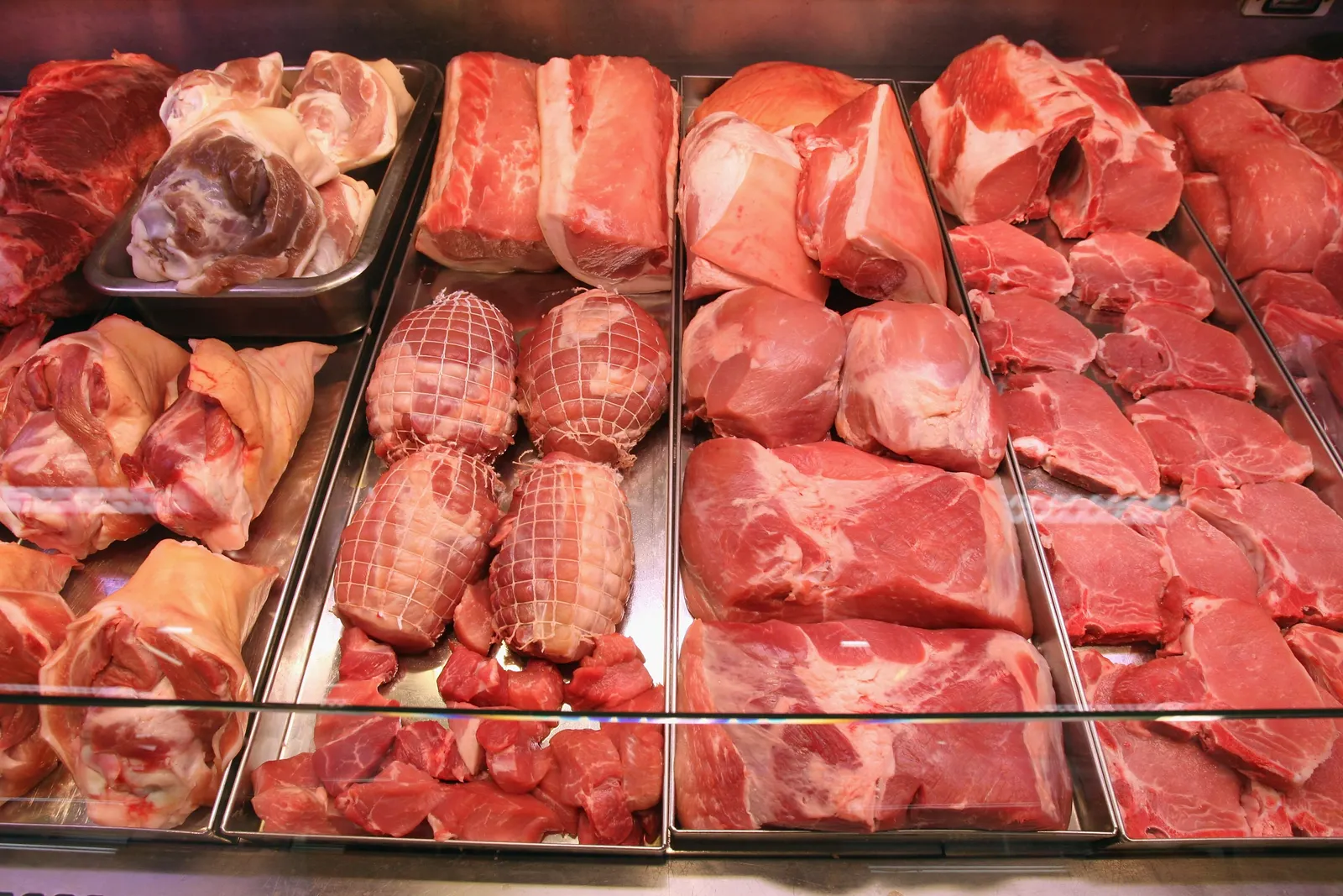 Variety of butchered meat in a display counter