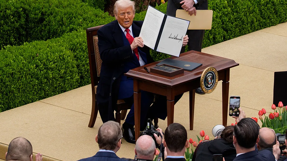 U.S. President Donald Trump holds his executive order imposing tariffs.