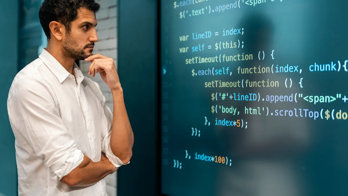 Professional software developer working late at night writing codes in an office.
