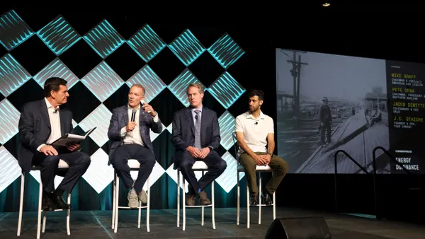 panelists sit on stage