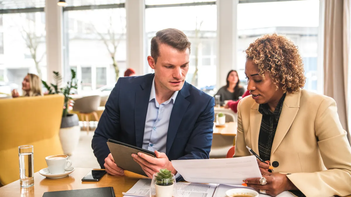 business partners sitting in a cafe having a meeting.