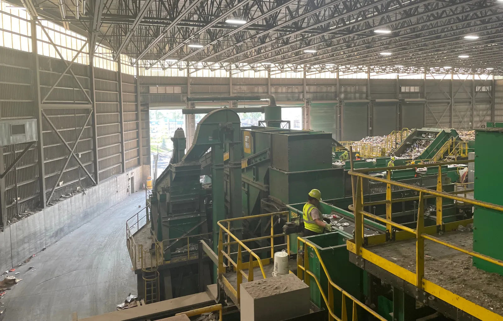 Worker standing in recycling facility