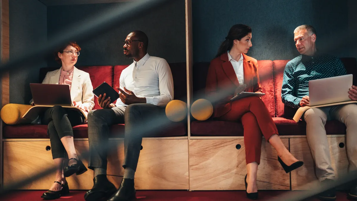 Business people working in separate booths