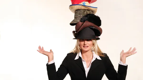 woman wearing a stack of hats on her head