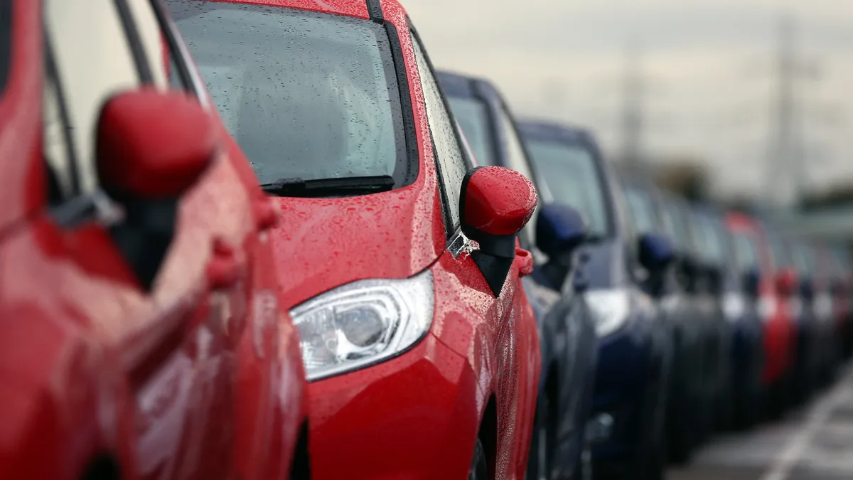 Cars are prepared for distribution at a Ford factory