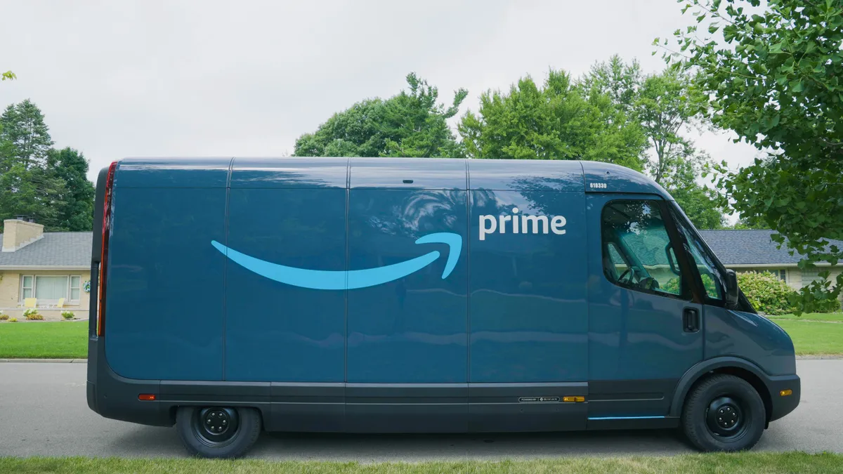 An Amazon delivery van made by Rivian sits in a neighborhood.