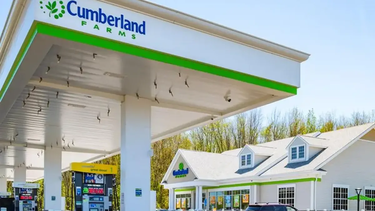 A photo of the exterior of a gas station and convenience store/ A sign on the fuel canopy says Cumberland Farms.