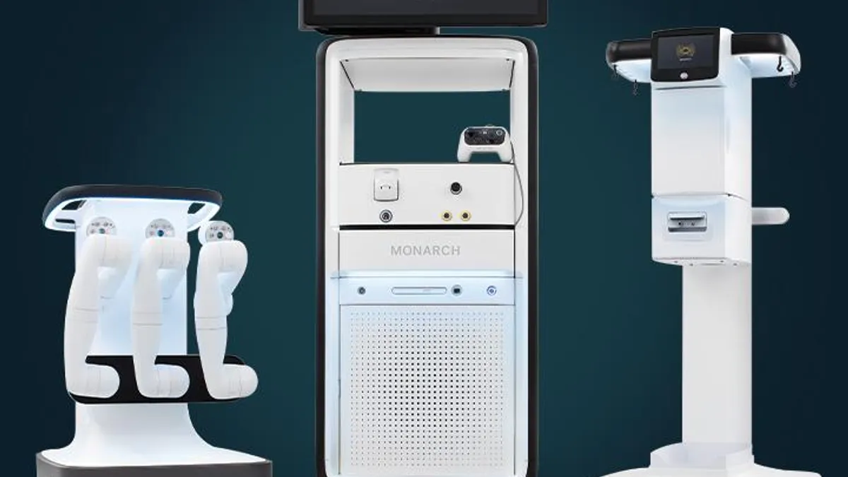 Three white machines that make up an Auris robotic surgery system