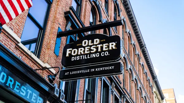 An Old Forester sign hangs above a distillery.