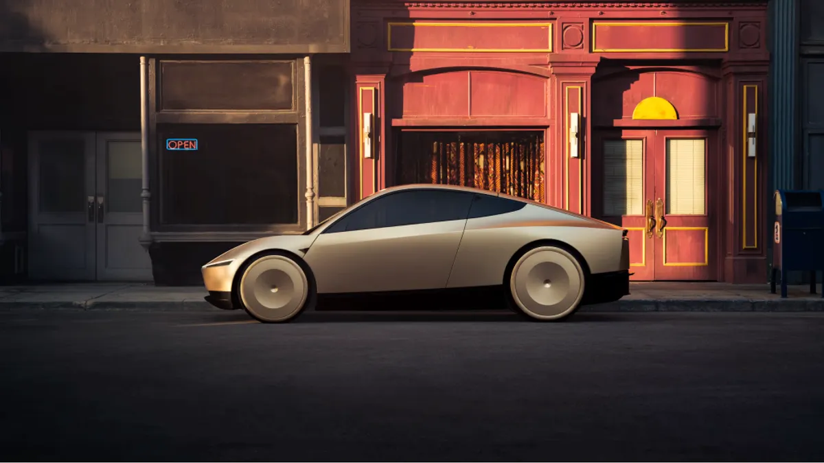 Side view of a two-door car parked at night with people sitting at tables on the sidewalk.