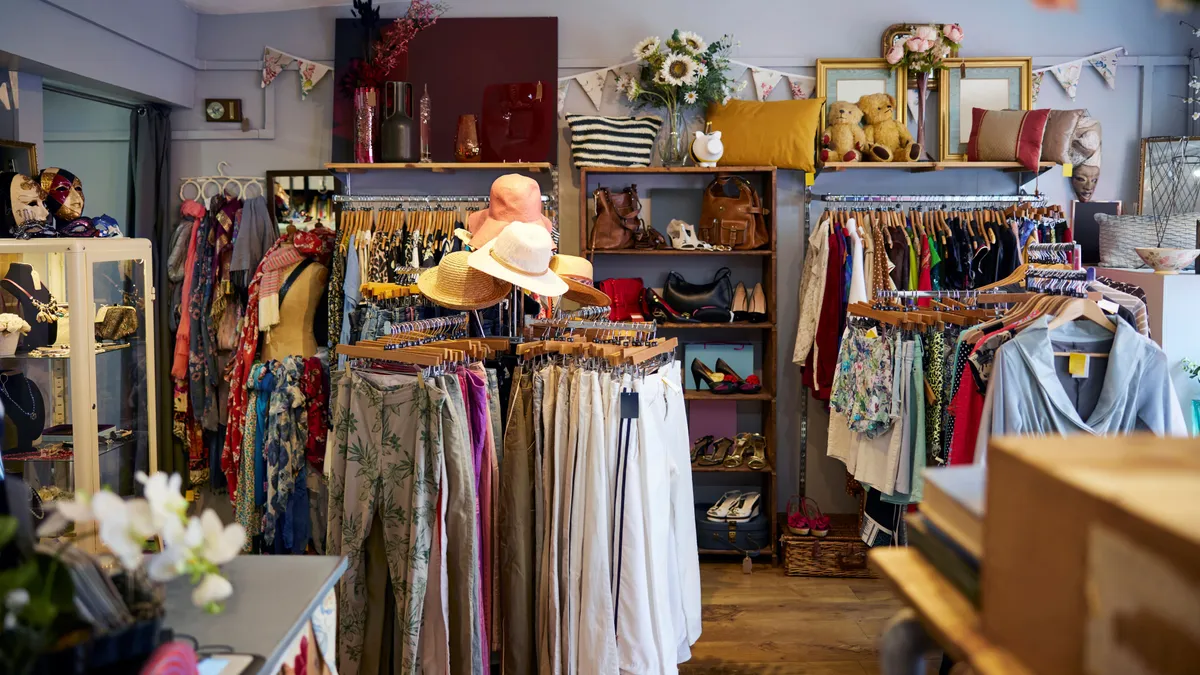 The interior of a thrift store shows apparel and accessories.