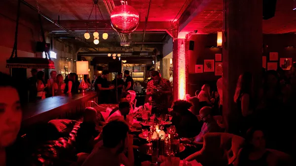 A bar filled with people at Soho House Chicago