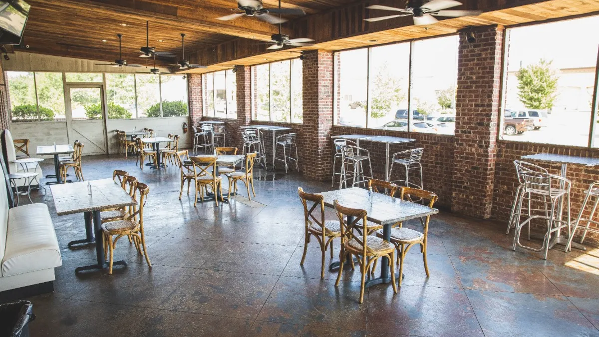 Socially distant tables inside Cotton Blues Kitchen & Marketplace's dining room in Hattiesburg, Mississippi