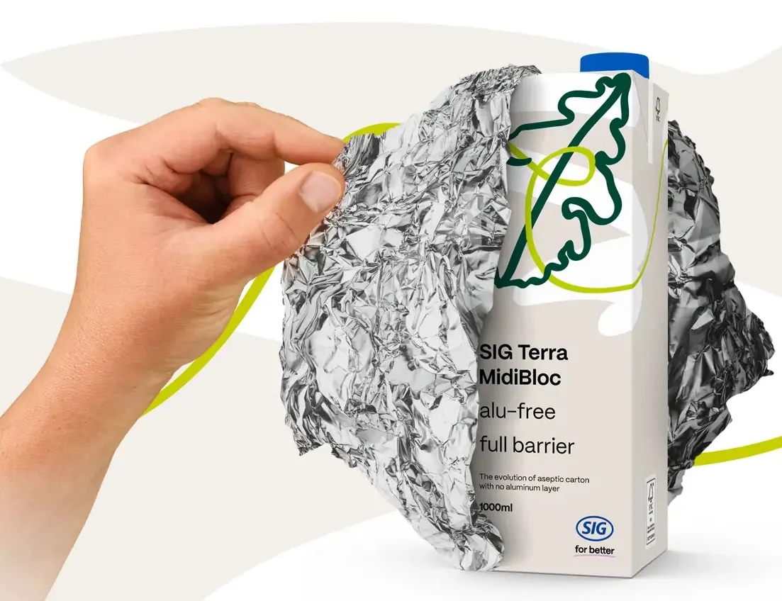 A person's hand pulls away aluminum foil covering part of an aseptic carton.