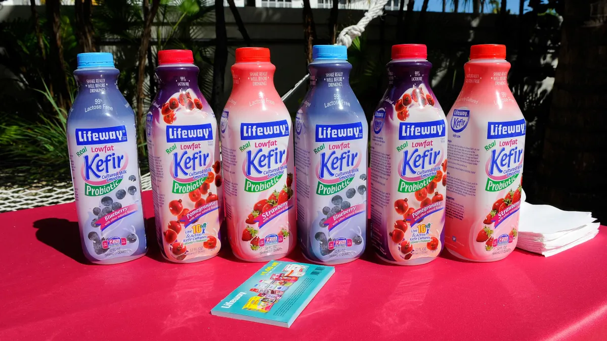 Bottles of Lifeway Kefir stand next to each other on a table.