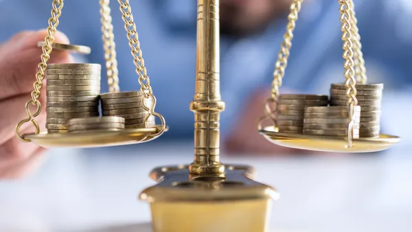 A balance scale with coins on both sides