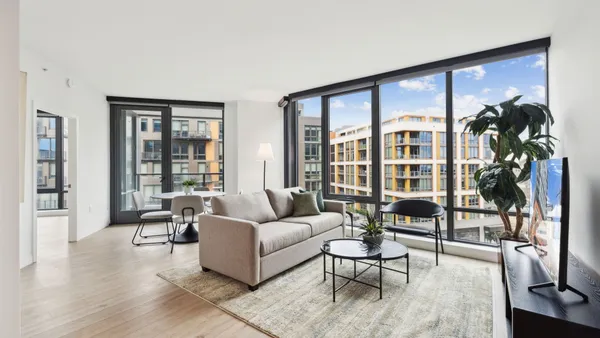 A furnished apartment-style hotel room at Placemakr's pop-up hotel at The Byron in Washington, D.C.