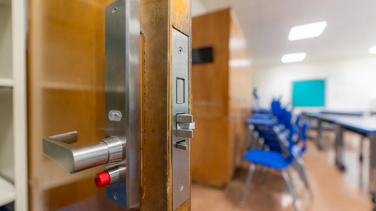 Open classroom door with new door hardware with security locks for a lockdown.