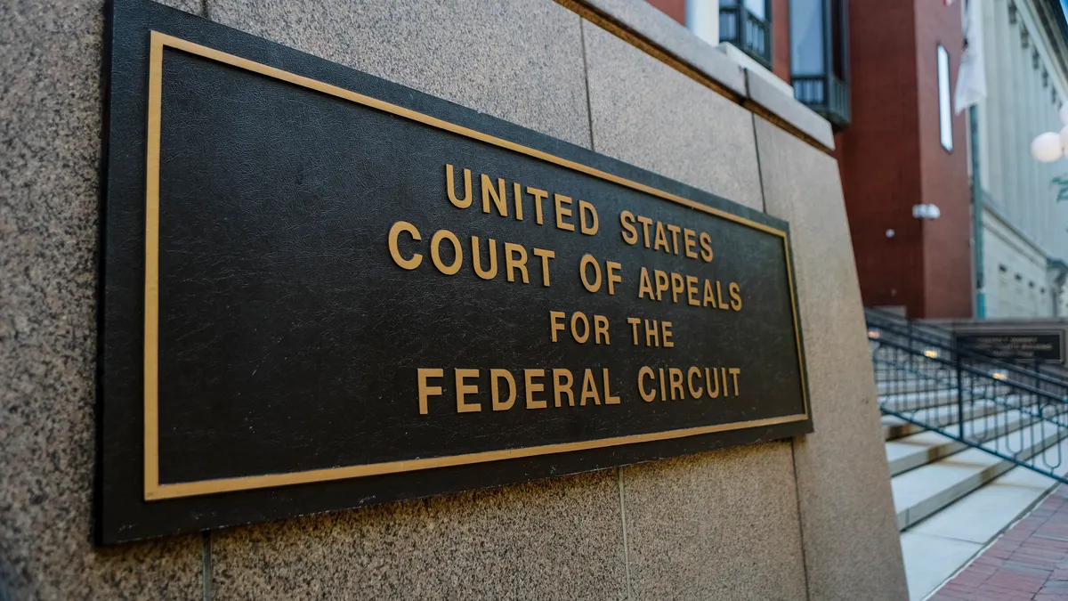 A sign on the outside of the U.S. Court of Appeals for the District of Columbia Circuit with stairs in the background.