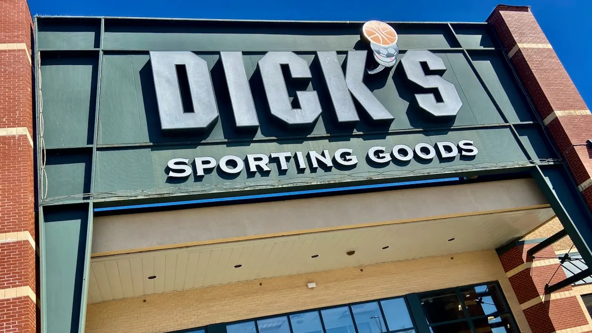 A sporting goods storefront against a bright blue sky