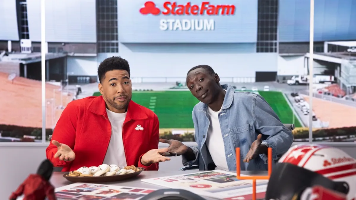 State Farm brand mascot Jake poses with TikTok creator Khaby Lame for the company's Super Bowl LVII social media contest.