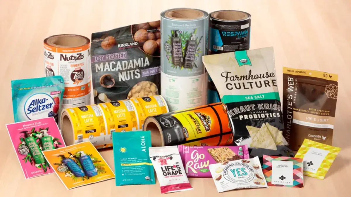 A variety of consumer products in flexible packaging, alongside rolls of flexible labels.