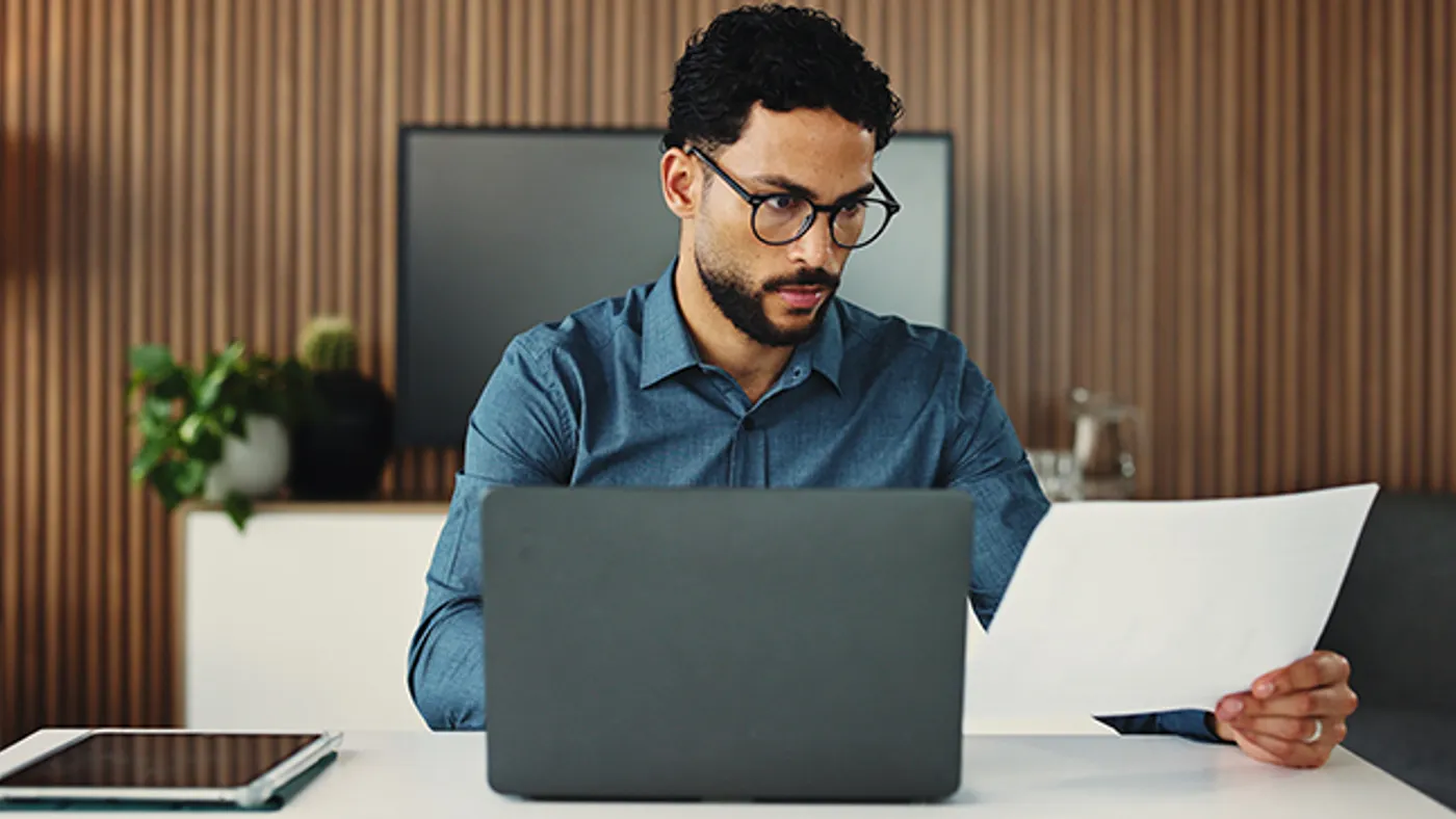 A man looking at papers while working