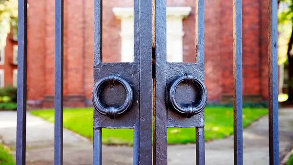 Image of college campus gate, closed.