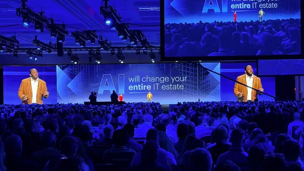 A gartner analyst gives a keynote speech in front of thousands of attendees.
