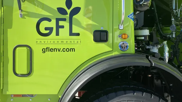 The GFL Environmental logo decal on the door of a large garbage truck