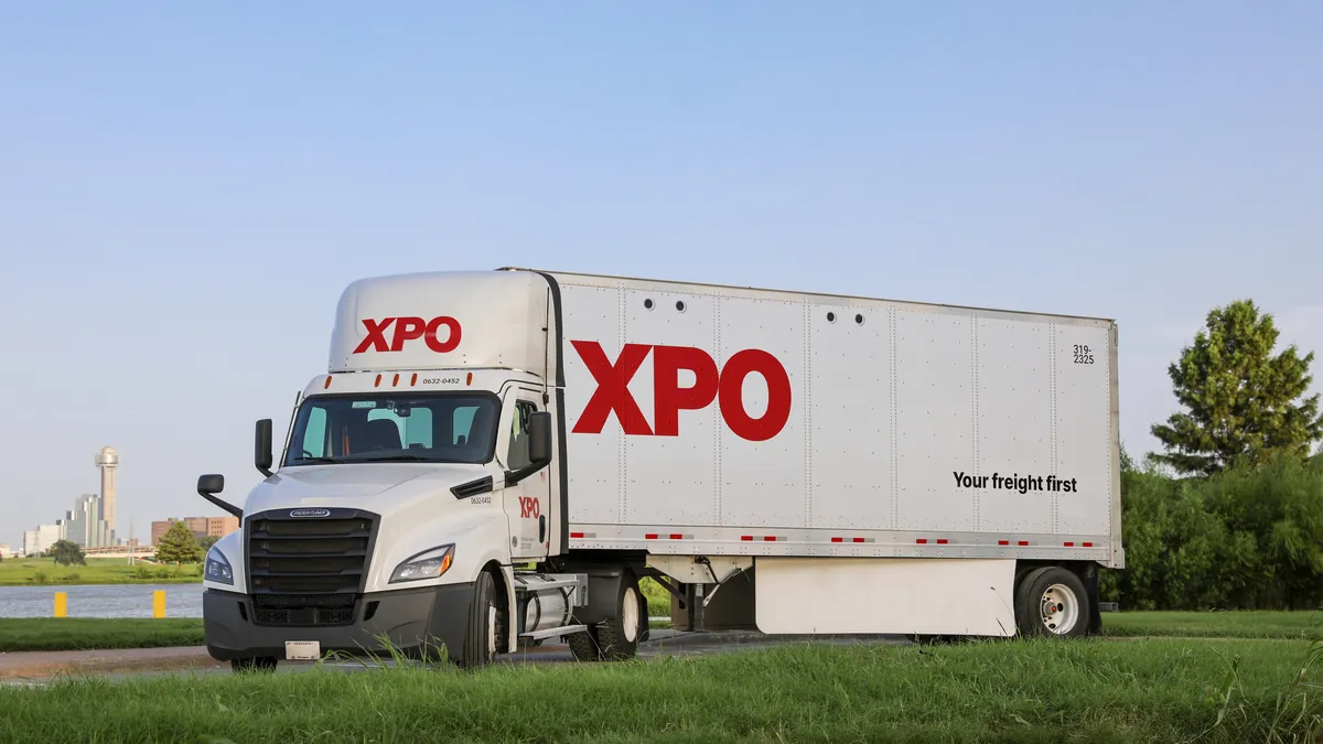 XPO logo on a semi-trailer truck on a highway.