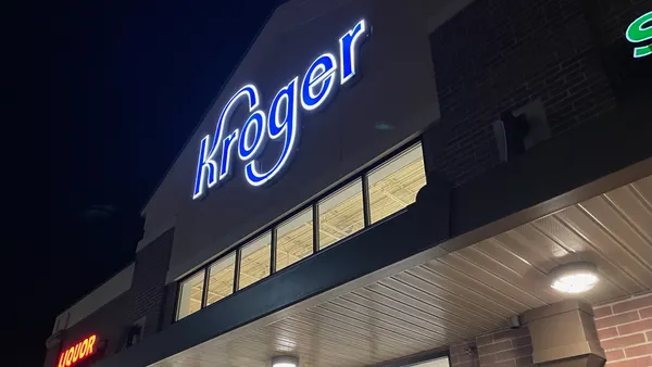 Exterior of a grocery store at night.