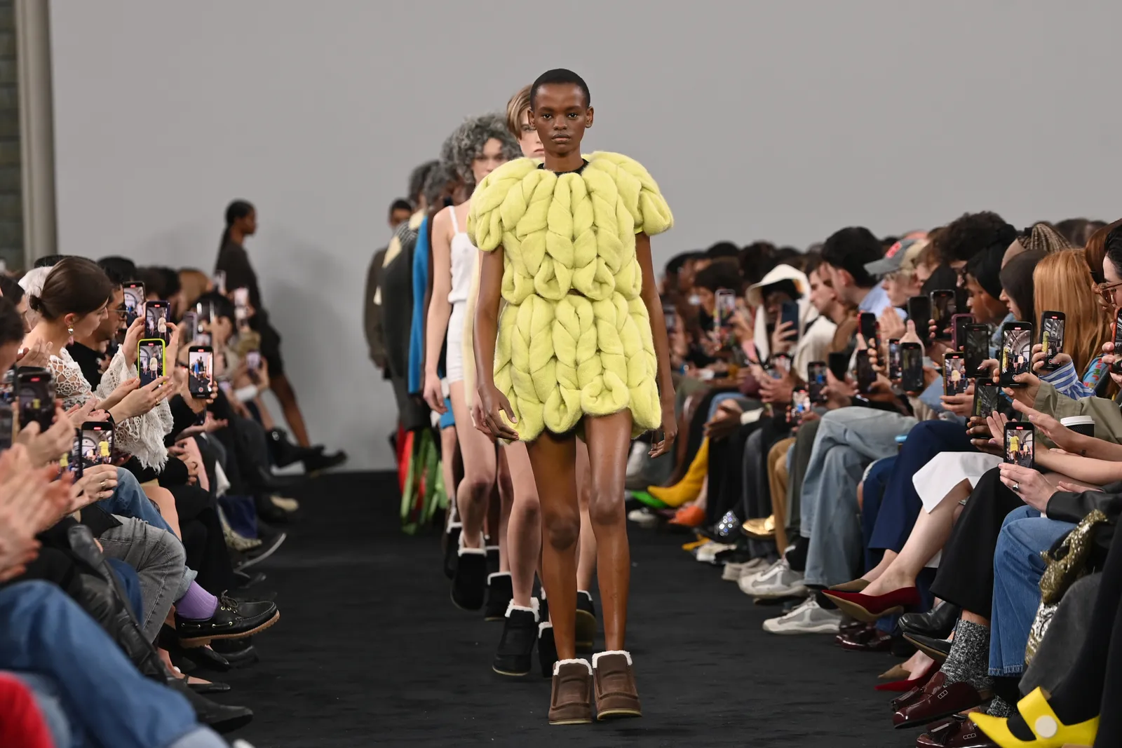 A model in a knit dress walks the runway at the JW Anderson show.