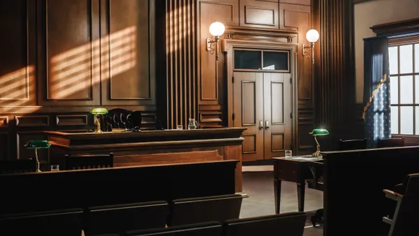 Empty American Style Courtroom. Supreme Court of Law and Justice Trial Stand. Courthouse Before Civil Case Hearing Starts. Grand Wooden Interior with Judge's Bench, Defendant's and Plaintiff's Tables.