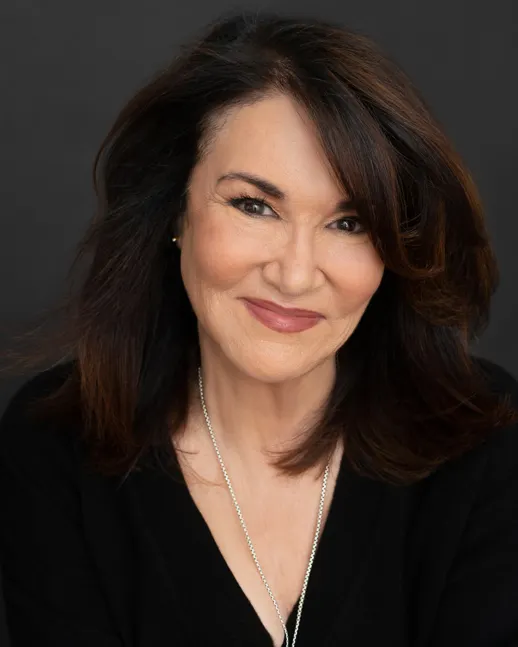 A person's headshot against a dark backdrop